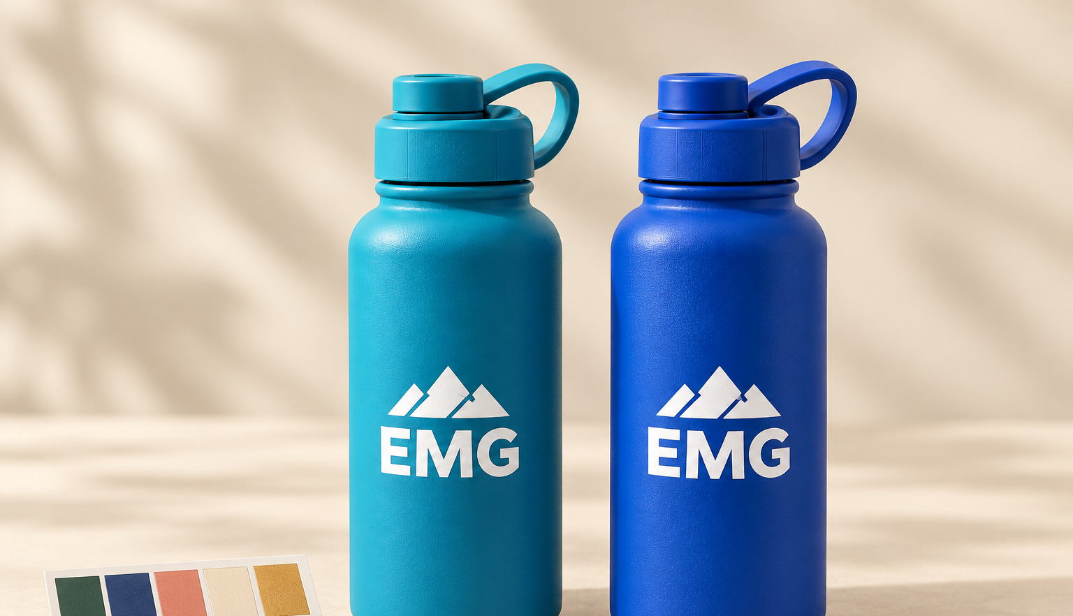 Color-matched teal and cobalt plastic bottles with white screen-printed EMG marks and a physical Pantone color strip